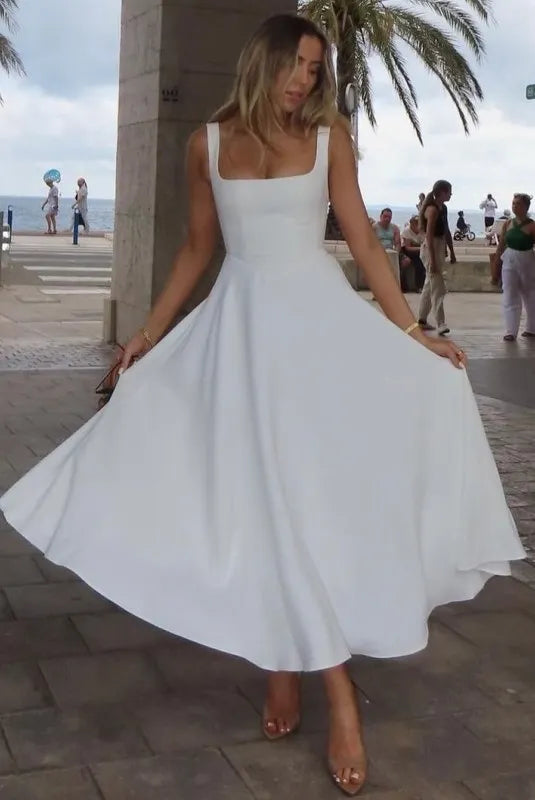 Clara women's midi dress with a high waist, square neckline, and a flowing skirt, in a solid color.