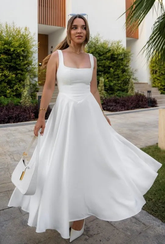 Clara women's midi dress with a high waist, square neckline, and a flowing skirt, in a solid color.