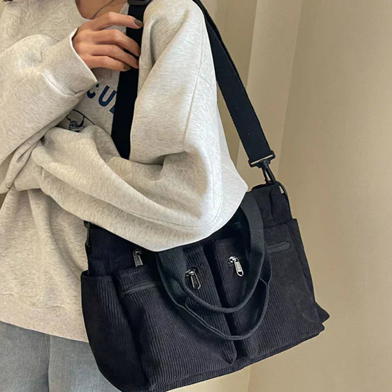 Celina women's handbag with a sleek, structured shape and two main zippered compartments.