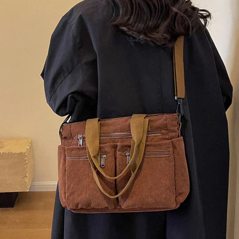 Celina women's handbag with a sleek, structured shape and two main zippered compartments.