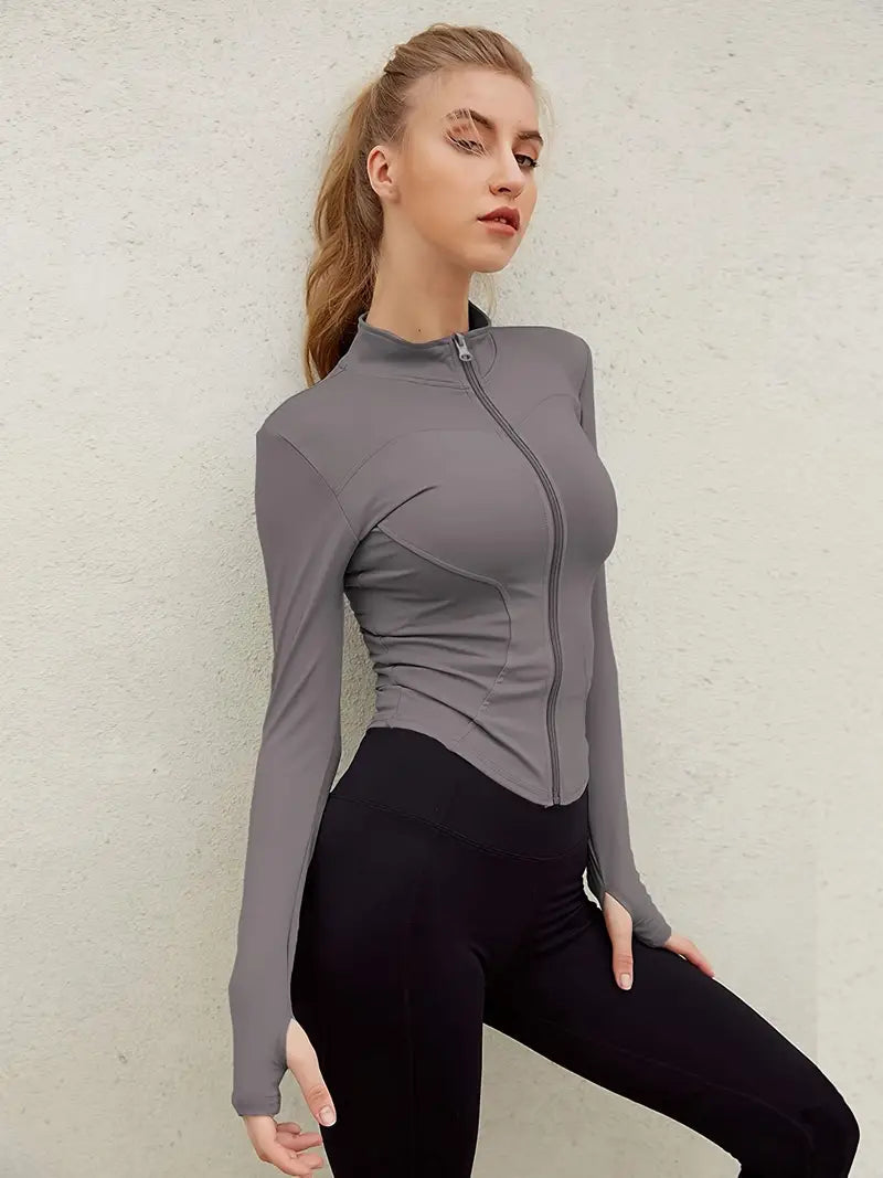 Zella women's sports jacket with a fitted cut, full zip, high collar, and thumb holes.