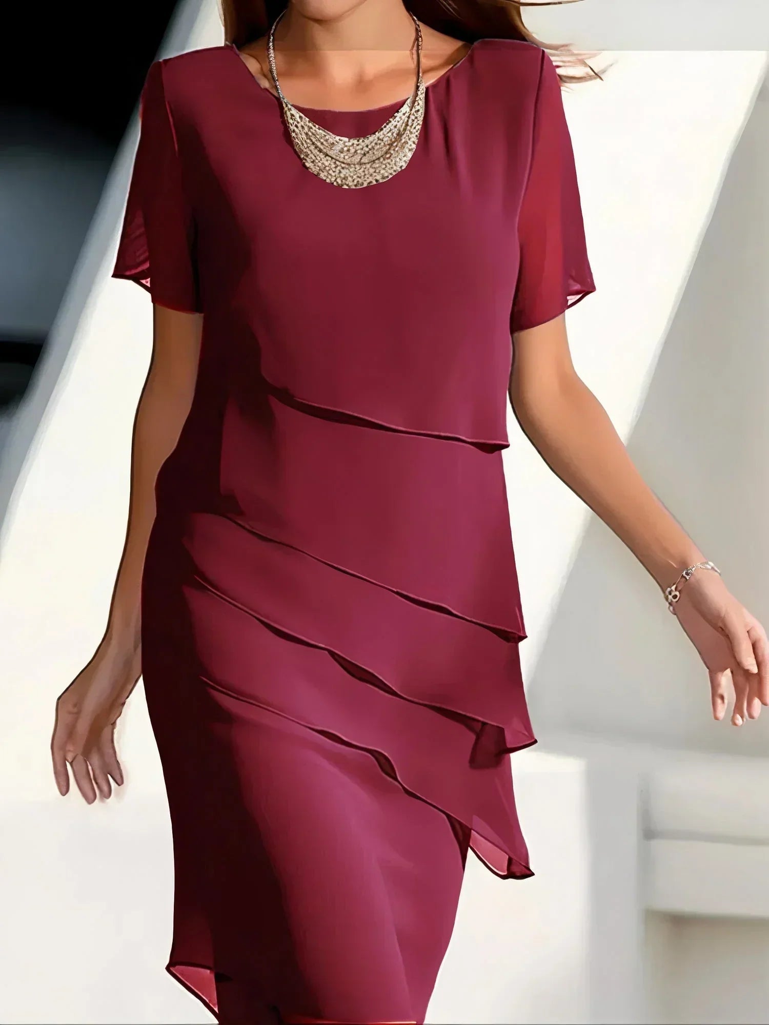 Elara women’s cocktail dress with layered diagonal ruffles and knee-length silhouette