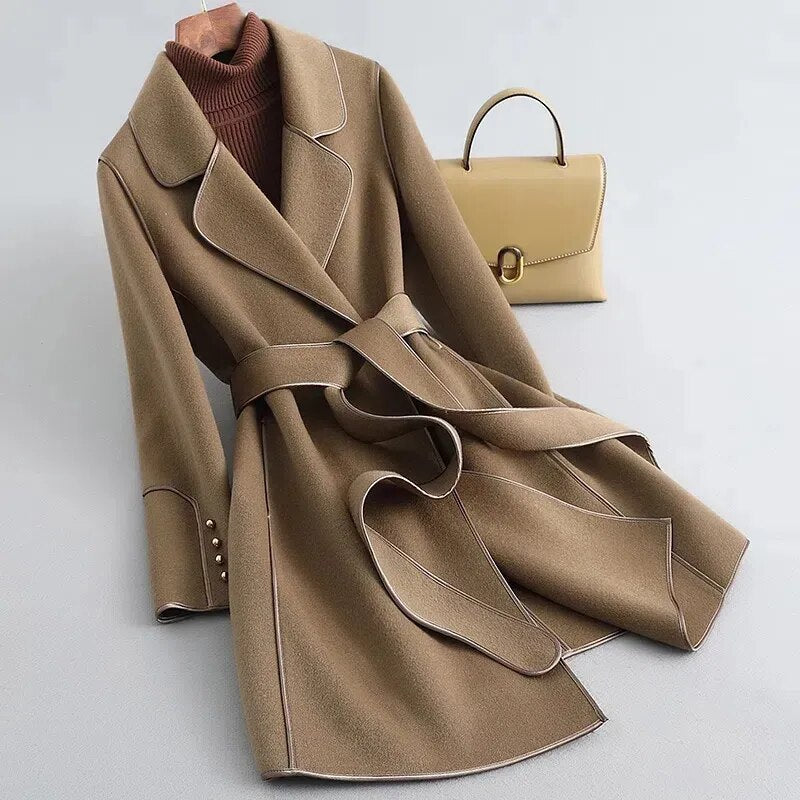 Amelia elegant women's long trench coat with a structured silhouette and a belted waist.