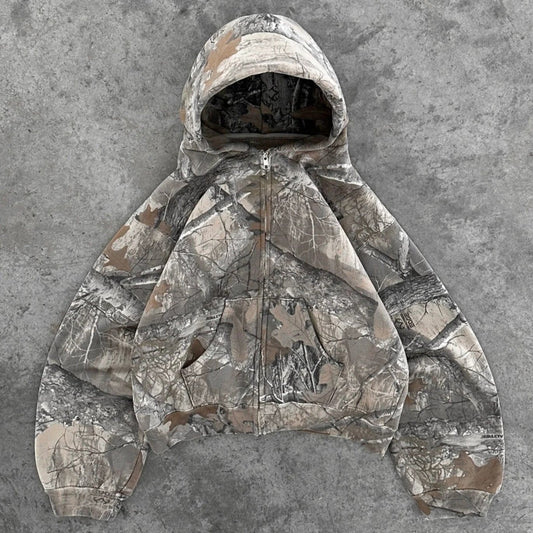 Hayden unisex hoodie with a camouflage pattern, zip closure, and a comfortable, relaxed fit.