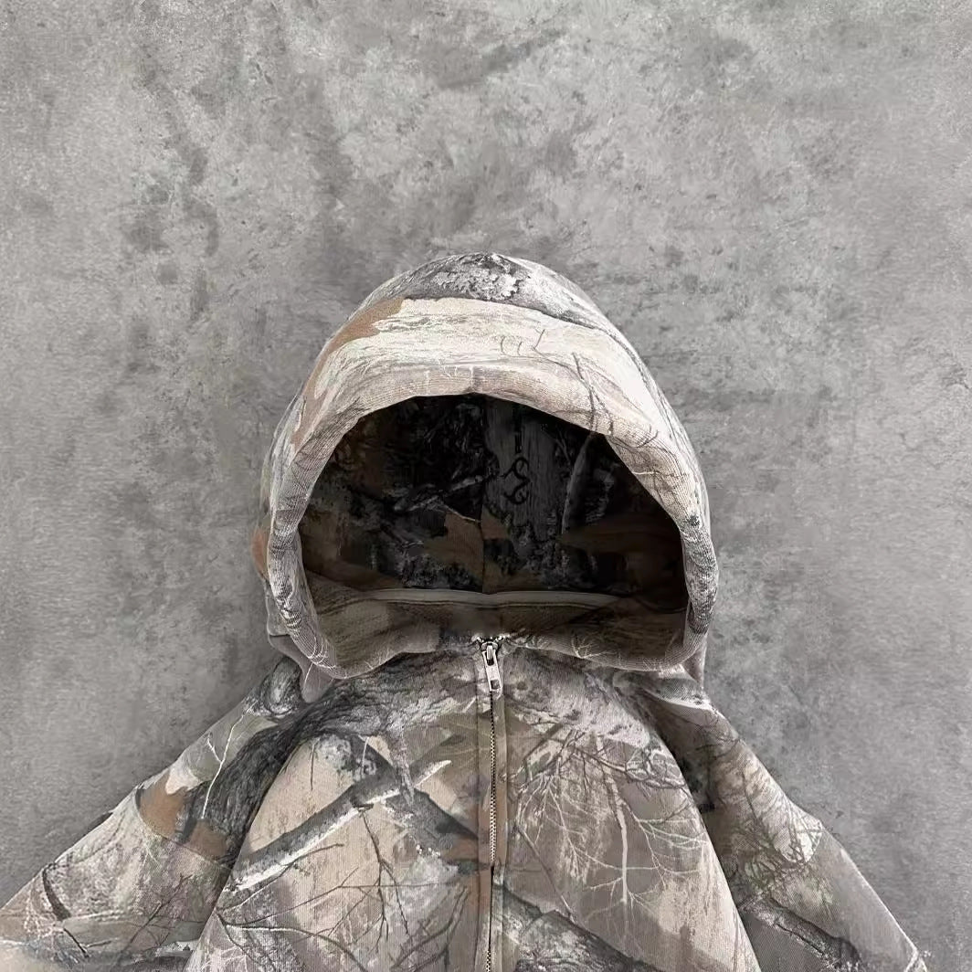 Hayden unisex hoodie with a camouflage pattern, zip closure, and a comfortable, relaxed fit.