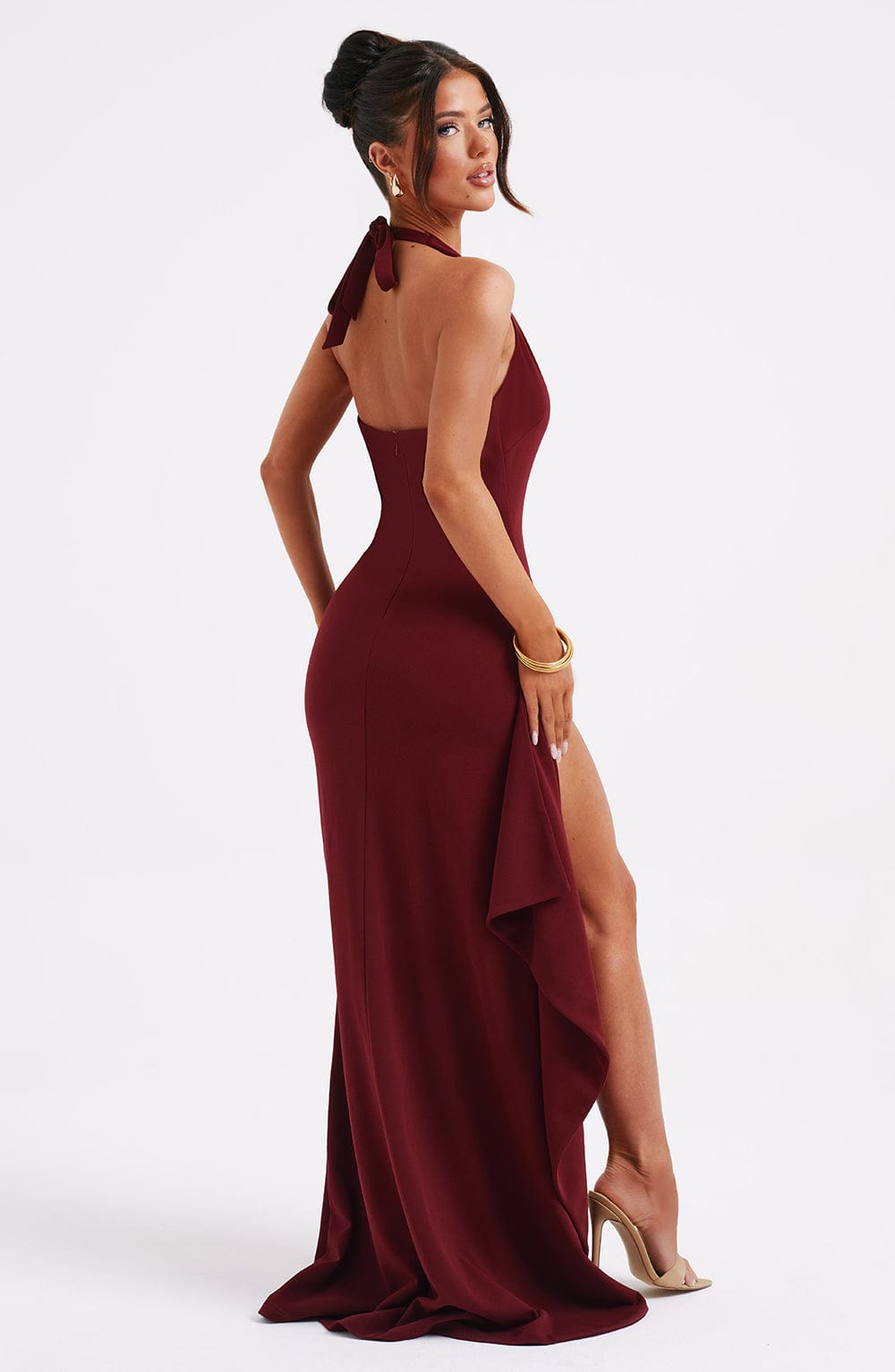 Maya elegant halter neck maxi dress with a flowing skirt and a subtle slit, in a solid color.