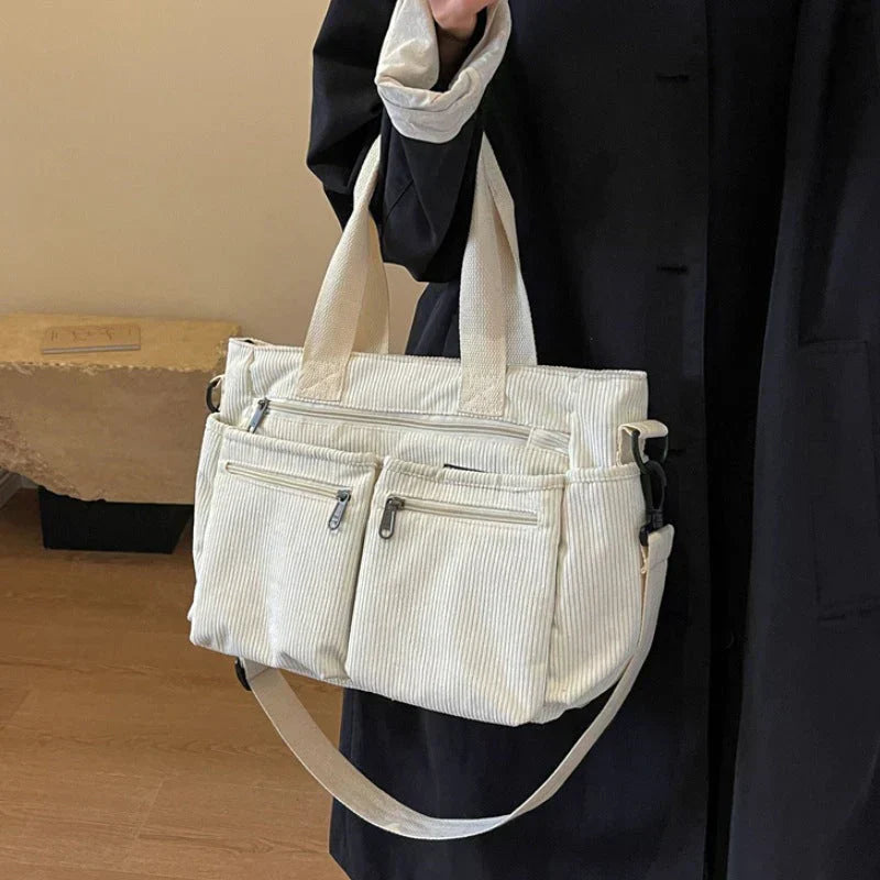 Celina women's handbag with a sleek, structured shape and two main zippered compartments.